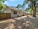 View of backyard area with partially covered patio and fenced perimeter at 6994 Fort King Rd, Zephyrhills, FL 33541