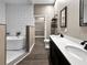 Bathroom with a freestanding tub, walk-in closet, double sinks, and dark wood cabinets at 6994 Fort King Rd, Zephyrhills, FL 33541