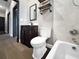 Bathroom with a tub, a dark wood vanity, and rustic shelving at 6994 Fort King Rd, Zephyrhills, FL 33541