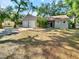 Charming single-story home with a two-car garage and lush, mature landscaping at 6994 Fort King Rd, Zephyrhills, FL 33541