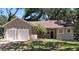 Charming single-story home featuring a two-car garage, landscaped yard, and a classic front entrance at 6994 Fort King Rd, Zephyrhills, FL 33541