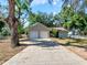 Charming single-story home featuring a two-car garage, long driveway and landscaped front yard at 6994 Fort King Rd, Zephyrhills, FL 33541