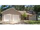 Charming single-story home featuring a two-car garage, landscaped yard, and a classic front entrance at 6994 Fort King Rd, Zephyrhills, FL 33541