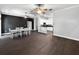 Spacious open-concept living and dining area with hardwood floors and modern lighting at 6994 Fort King Rd, Zephyrhills, FL 33541