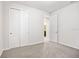 Bright bedroom featuring neutral walls, plush carpeting, closet, and ensuite door at 9309 Tradewater Oaks Ct, Riverview, FL 33578