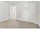 Bright bedroom featuring neutral walls, plush carpeting, closet, and ensuite door at 9309 Tradewater Oaks Ct, Riverview, FL 33578