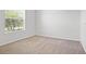 Neutral bedroom featuring carpet and a bright window at 9309 Tradewater Oaks Ct, Riverview, FL 33578