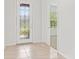 Light-filled entryway featuring decorative glass front door and tile flooring at 9309 Tradewater Oaks Ct, Riverview, FL 33578