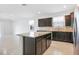 Kitchen island featuring dark wood cabinets and granite countertop with tile flooring at 9309 Tradewater Oaks Ct, Riverview, FL 33578