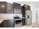Kitchen with granite counters, stainless appliances, and dark wood cabinetry at 9309 Tradewater Oaks Ct, Riverview, FL 33578