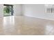 Spacious living room featuring tile flooring and a sliding door to the backyard at 9309 Tradewater Oaks Ct, Riverview, FL 33578