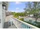 Charming balcony with seating, overlooking a serene backyard and neighborhood street at 1001 S Oregon Ave, Tampa, FL 33606