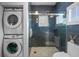 Contemporary bathroom with a glass shower, stackable washer/dryer, and modern fixtures at 1001 S Oregon Ave, Tampa, FL 33606