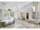 Light-filled bathroom with free-standing tub, double vanity, and large mirrors at 1001 S Oregon Ave, Tampa, FL 33606