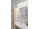 White bathroom featuring subway tile and a framed mirror at 1001 S Oregon Ave, Tampa, FL 33606