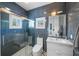 Modern bathroom with textured blue tile walls, glass-enclosed shower, and sleek vanity at 1001 S Oregon Ave, Tampa, FL 33606