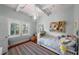 A cozy bedroom with a vaulted ceiling, wooden beams and a brightly colored rug at 1001 S Oregon Ave, Tampa, FL 33606