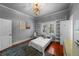 A bedroom featuring shelving units, white trim, and a globe on display at 1001 S Oregon Ave, Tampa, FL 33606