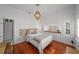 Cozy bedroom showcasing hardwood floors, a stylish headboard, and built in dresser at 1001 S Oregon Ave, Tampa, FL 33606