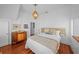 Bedroom with hardwood floors, a decorative chandelier, and a vintage wooden dresser at 1001 S Oregon Ave, Tampa, FL 33606