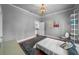 Neutral bedroom featuring sleek shelving, hardwood floors, and a view to another room at 1001 S Oregon Ave, Tampa, FL 33606