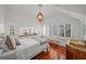 Bright bedroom featuring hardwood floors, large windows with shutters, and a decorative chandelier at 1001 S Oregon Ave, Tampa, FL 33606