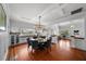 Open-concept dining area featuring hardwood floors and views of a modern light fixture at 1001 S Oregon Ave, Tampa, FL 33606