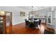 A dining room with hardwood floors, a round table, six chairs, and a modern chandelier at 1001 S Oregon Ave, Tampa, FL 33606