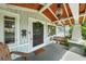 Inviting front porch with a wooden swing and a stylish pineapple pendant light at 1001 S Oregon Ave, Tampa, FL 33606