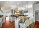 Well-lit kitchen with stainless steel appliances, center island with seating, and hardwood floors at 1001 S Oregon Ave, Tampa, FL 33606