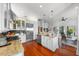Bright, open kitchen featuring stainless steel appliances, granite countertops and wood floors at 1001 S Oregon Ave, Tampa, FL 33606