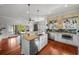 Spacious kitchen with stainless appliances, island with counter seating, and access to the living room at 1001 S Oregon Ave, Tampa, FL 33606