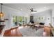 Comfortable living room with hardwood floors, ceiling fan, and sliding glass doors to outdoor patio at 1001 S Oregon Ave, Tampa, FL 33606
