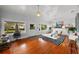 Spacious living room with hardwood floors, a decorative fireplace, and stylish modern furnishings at 1001 S Oregon Ave, Tampa, FL 33606