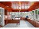 Wood-paneled office featuring custom built-ins, tiled floors, and bright, natural light at 1001 S Oregon Ave, Tampa, FL 33606