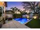 Private backyard featuring a sparkling swimming pool, lush landscaping, and patio area at 1001 S Oregon Ave, Tampa, FL 33606