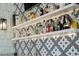 Close up of wet bar with grey and white mosaic tiling and floating shelves with a variety of spirits at 1001 S Oregon Ave, Tampa, FL 33606