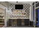 This wet bar includes a sink, a beverage refrigerator and eye catching designer tile at 1001 S Oregon Ave, Tampa, FL 33606