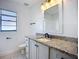 Bathroom with granite vanity, a window, and modern fixtures at 1005 Cameo Crest Ln, Valrico, FL 33596