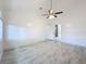 A spacious bedroom featuring sleek marble tile, a ceiling fan and an entrance to a bathroom with a shower at 1005 Cameo Crest Ln, Valrico, FL 33596