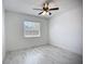 A cozy bedroom featuring a ceiling fan and a window at 1005 Cameo Crest Ln, Valrico, FL 33596