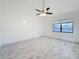 A spacious bedroom featuring sleek marble tile, a ceiling fan and a window with blinds at 1005 Cameo Crest Ln, Valrico, FL 33596