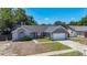 Exterior elevation showcasing the home's light blue front door, stone accents, and an attached garage at 1005 Cameo Crest Ln, Valrico, FL 33596