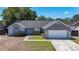 Charming home features a light blue front door, stone accents, and a well-maintained yard at 1005 Cameo Crest Ln, Valrico, FL 33596