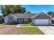 Charming home features a light blue front door, stone accents, and a well-maintained yard at 1005 Cameo Crest Ln, Valrico, FL 33596