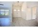 Bright foyer featuring double doors, modern light fixture, and seamless access to living spaces at 1005 Cameo Crest Ln, Valrico, FL 33596