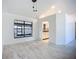 Open living room with modern light fixtures and large windows showcases space and natural light at 1005 Cameo Crest Ln, Valrico, FL 33596
