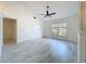 Bright living room with a ceiling fan and large windows provides natural light and comfort at 1005 Cameo Crest Ln, Valrico, FL 33596