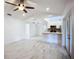 Spacious living room features modern flooring, ceiling fan, and an open layout to the kitchen at 1005 Cameo Crest Ln, Valrico, FL 33596