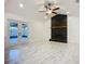 Spacious living room featuring sleek tile flooring, large windows, stone fireplace and backyard views at 1005 Cameo Crest Ln, Valrico, FL 33596